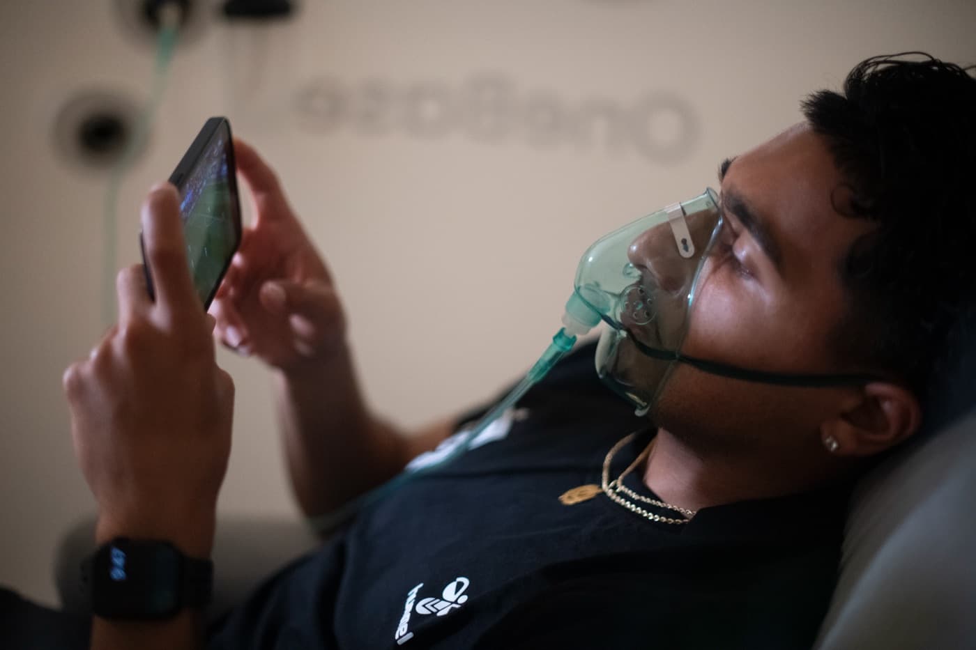 An athlete breathing through an oxygen mask during a hyperbaric session