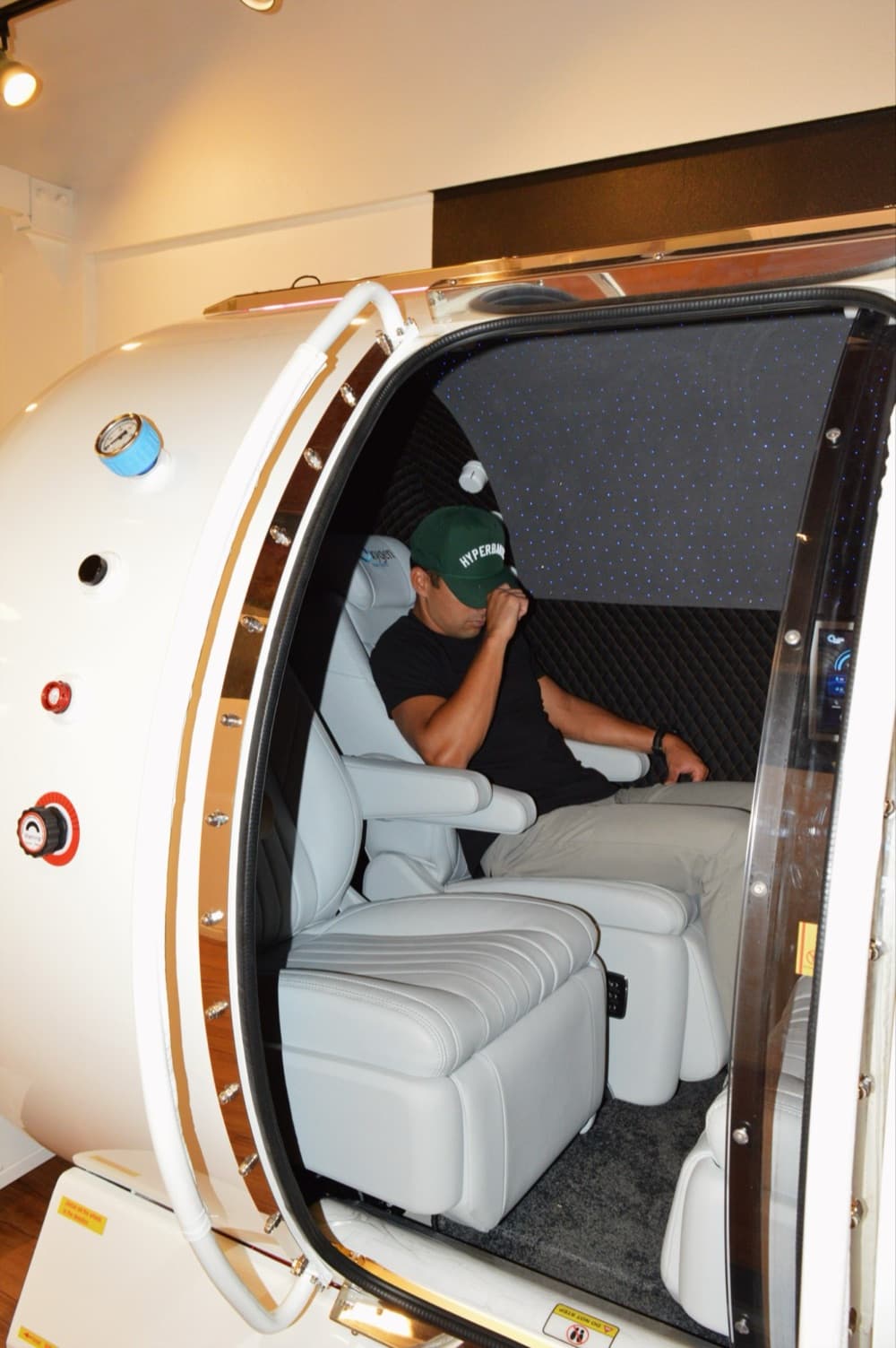 A member seated inside Hype's 4-person hard hyperbaric chamber