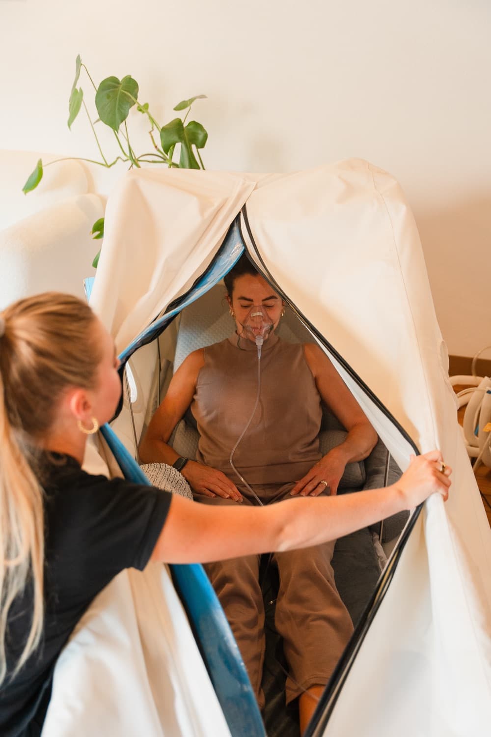 A member breathing oxygen inside a soft hyperbaric chamber