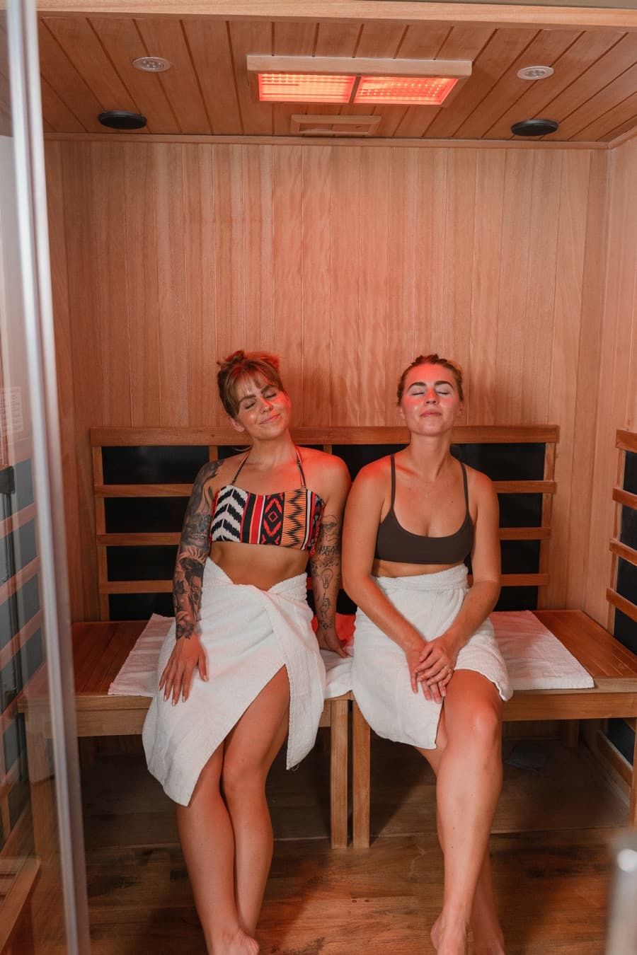 Two members relaxing together in the infrared sauna